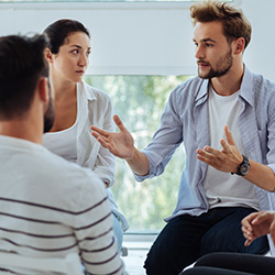 Computing professionals standing in a circle practicing communication techniques